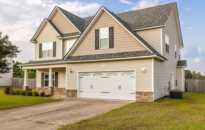 Welcome to this charming 4-bedroom, 3.5-bath home in Raeford