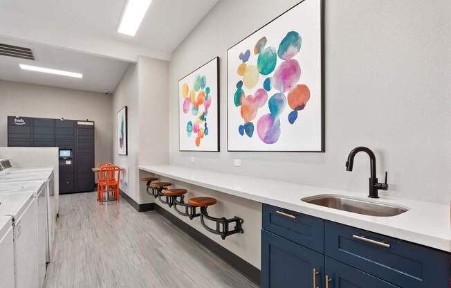 A kitchen with a white counter top and a sink.