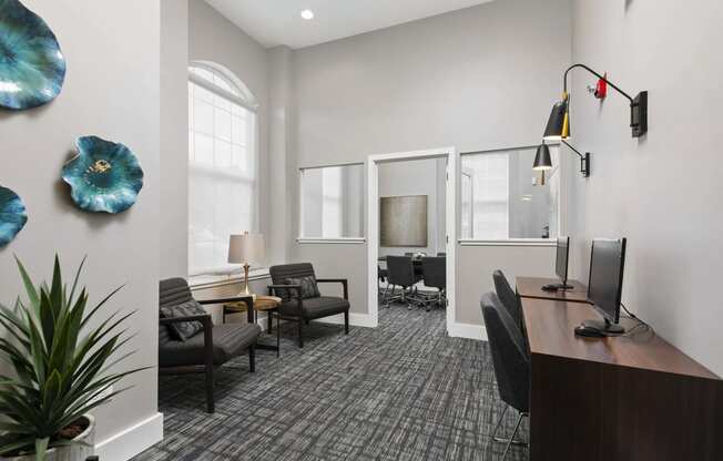 an office with a desk and chairs and a window