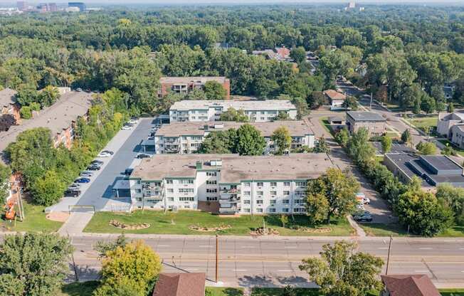 A large white building with a parking lot in front of it.