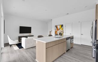 a kitchen and living room with white walls and wood floors at The Franklin Marlboro Apartments, Marlboro, NJ