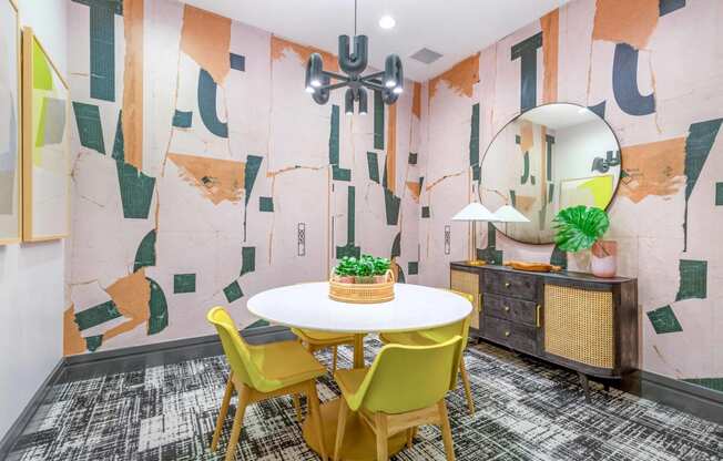 a dining room with a white table and yellow chairs