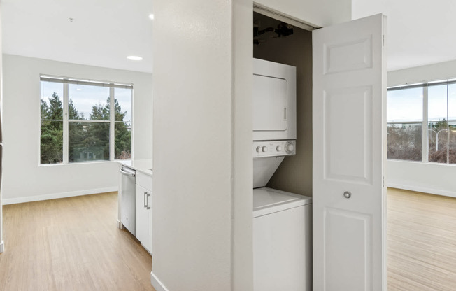 Kitchen with island and hard surface flooring and in-home washer and dryer