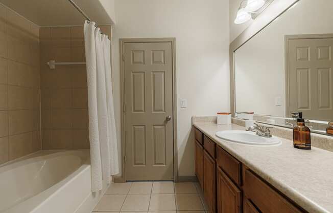 a full view of a bathroom with a sink and a tub