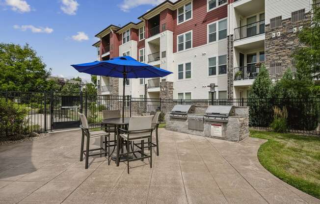 BBQ grilling station with picnic tables - Enclave at Cherry Creek