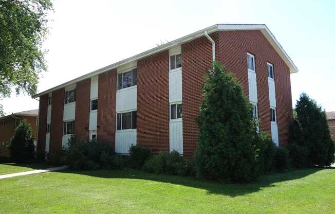 A red brick building with white trim and windows.