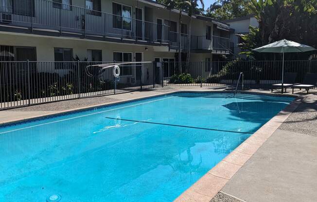 Swimming pool and apartments in gated courtyard of Los Robles Apartments in Pasadena, California.