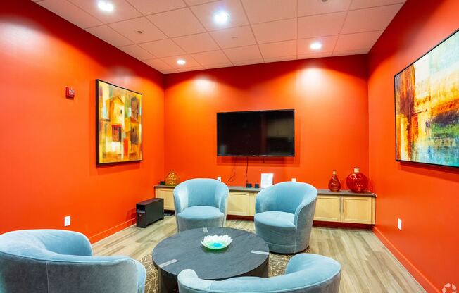 A living room with orange walls and a television at 603 Concord Apartments, Cambridge, MA, 02138