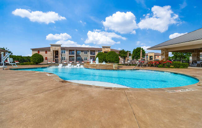 a swimming pool with a building in the background