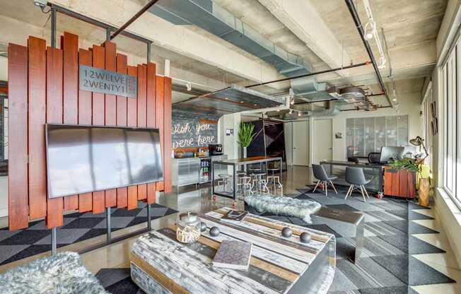A modern office space with a wooden partition and a coffee table in the foreground.