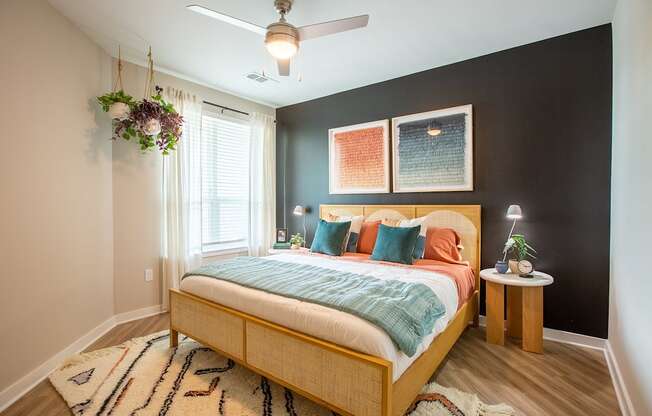 a bedroom with a bed and a ceiling fan