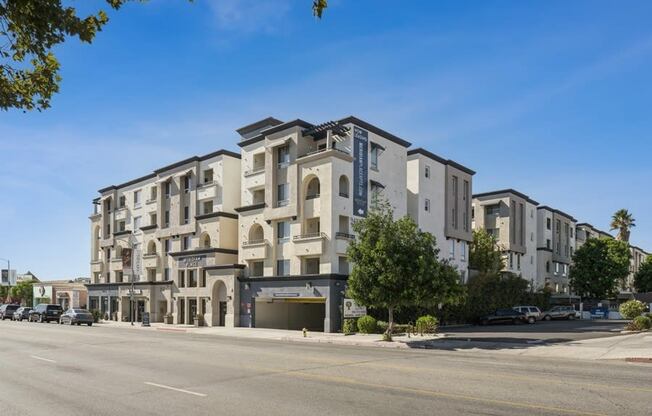 a large apartment building on the corner of a street