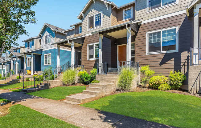 A row of town houses with green lawns and landscaping at The Landing Apartments and Townhomes in Oregon City, Oregon