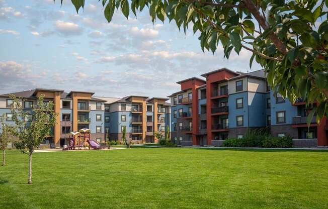 Apartment complex with a playground in the foreground.