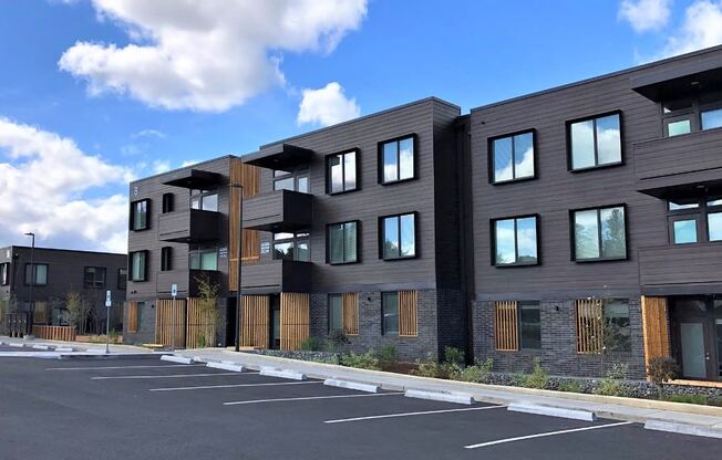 a row of new apartment buildings in a parking lot