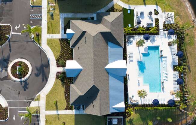 a birds eye view of a house with a swimming pool in the backyard