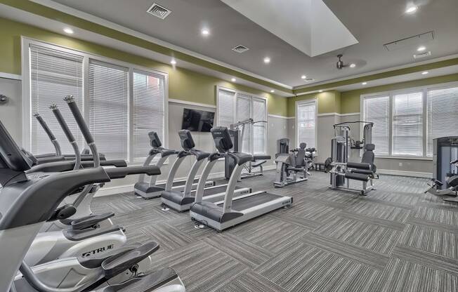 a gym with cardio equipment and windows at Nexus at Sandhill, Columbia