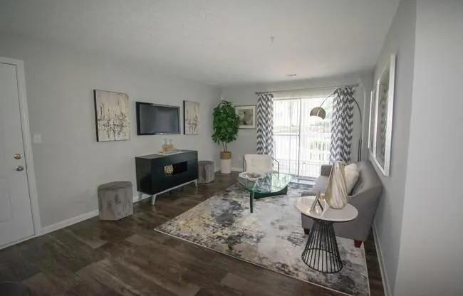 a living room with a couch and a television at The Sapphire, Georgia, 30035