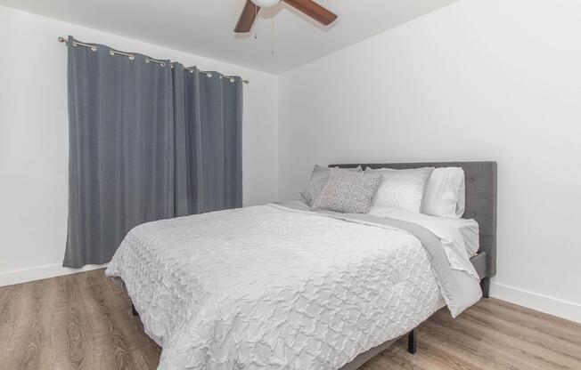 a bedroom with a bed and a curtain