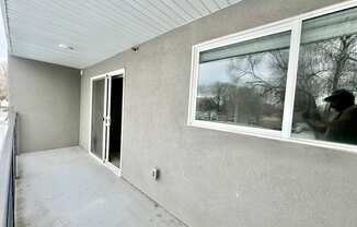 a view of the side of a house with a window and a door