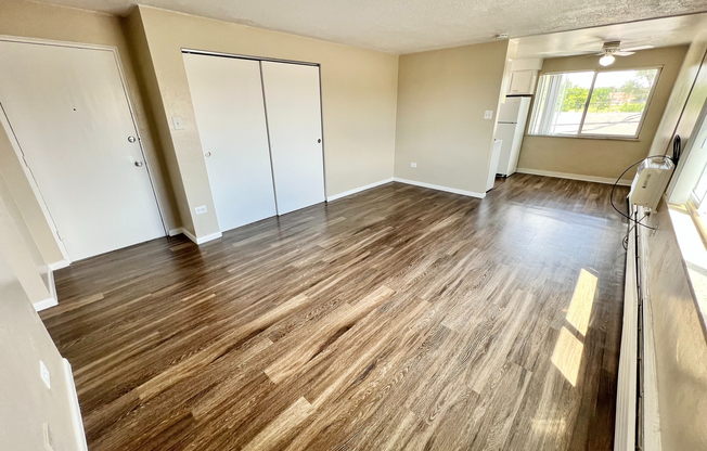 Bright and spacious apartment with beautiful wood flooring and ample natural light, offering a modern open layout.
