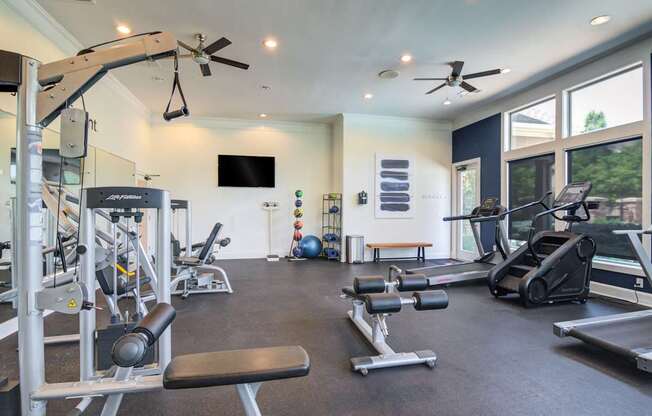 A spacious home gym with a variety of exercise equipment.