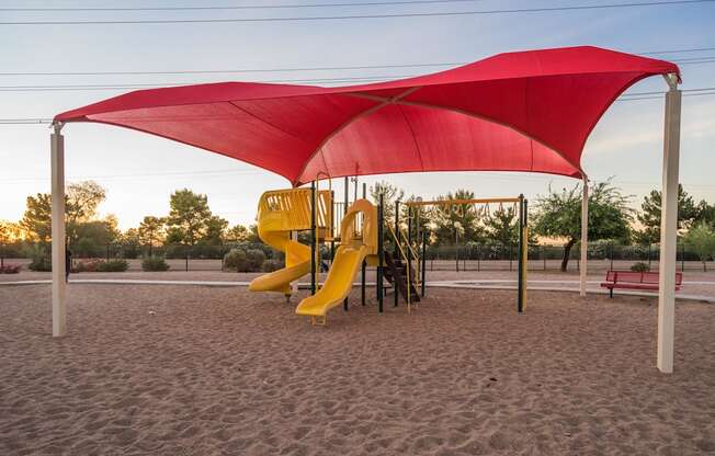 A playground with a red canopy and a yellow slide at Sterling Point Apartment Homes, Phoenix, AZ, 85042