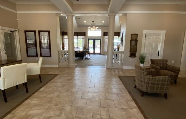 a large hallway with chairs and tables and a couch