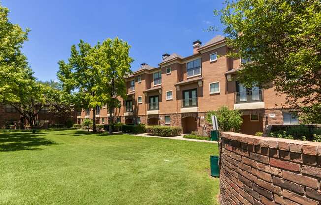 This is a photo of the building exteriors/the courtyard at The Brownstones Townhome Apartments in Dallas, TX.