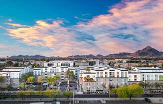 A cityscape with buildings and a mountain in the background.