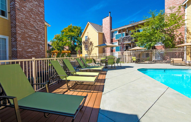 our apartments have a large pool and a deck with chairs at Skyview Apartments, Westminster, CO
