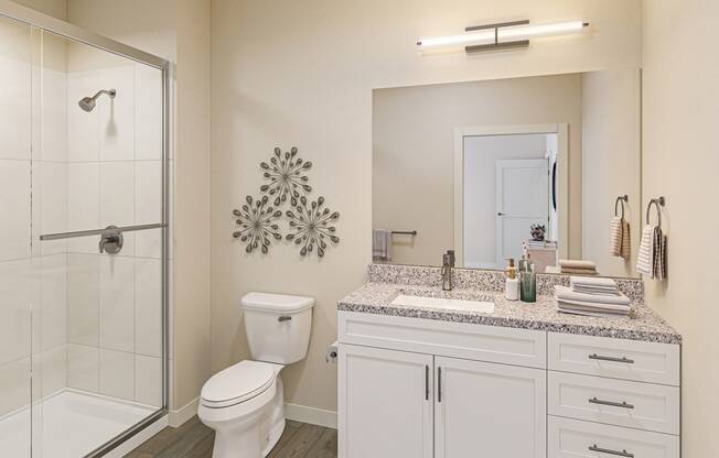 a bathroom with a toilet and a shower and a sink