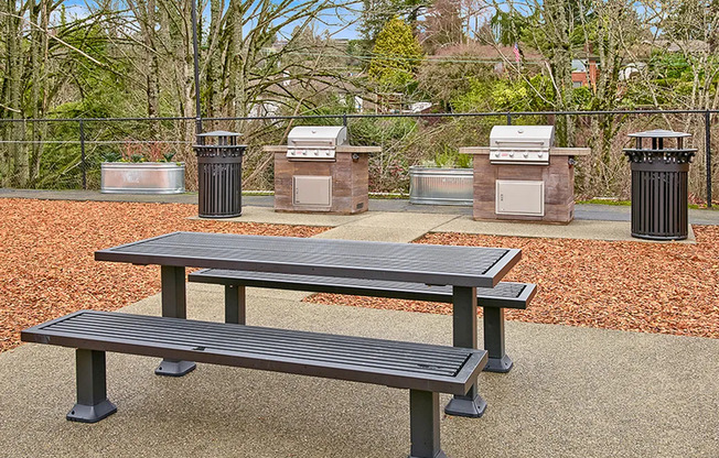 Renton Apartments for Rent - Sunset View - Picnic Table with Two Grills and Wood Chips