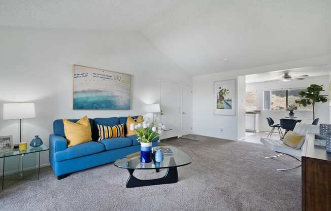 a living room with a blue couch and a coffee table