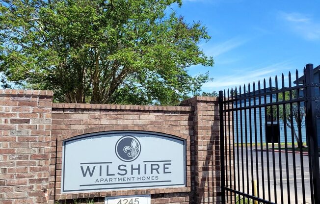 a sign that says wilshire at the entrance of the property