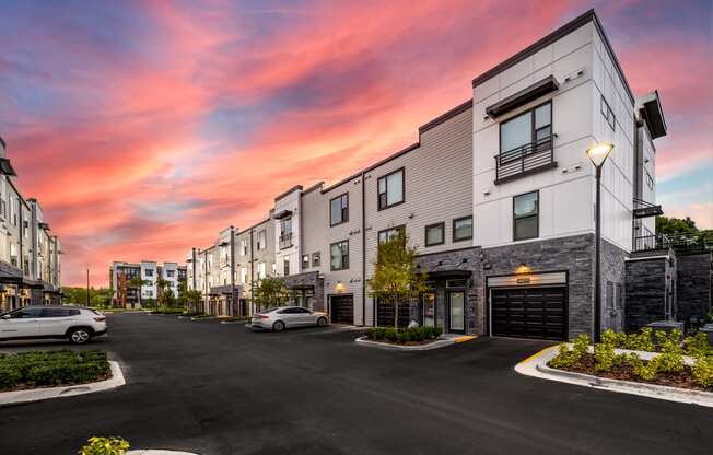 an empty street with buildings at sunset