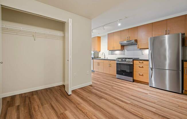A kitchen with wooden floors and stainless steel appliances.