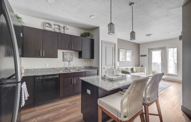 an open kitchen and living room with a table and chairs