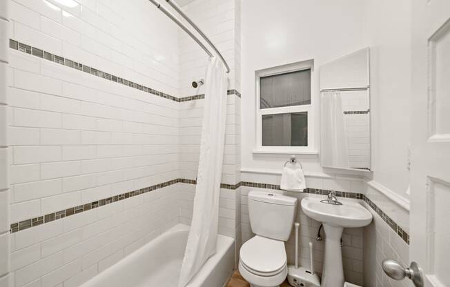 a bathroom with a toilet and a sink and a tub