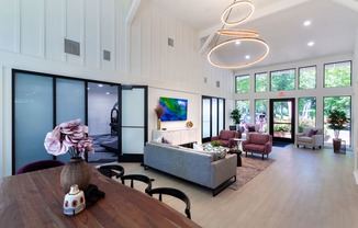 a living room filled with furniture and a large window