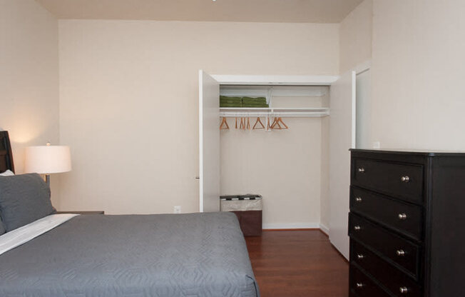 a bedroom with a bed and a dresser