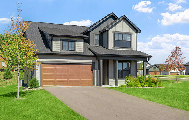 a house with a garage door and a driveway