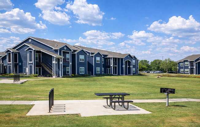 A row of houses with a picnic table in front.