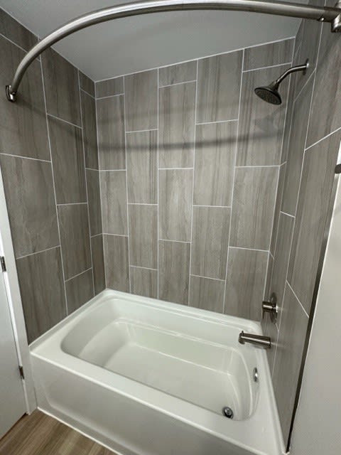 Ceramic Tile Bathtub to Ceiling With Upgraded Showerhead