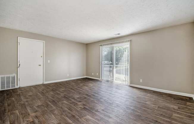 Omaha, NE Maple Ridge Apartments. A living room with a sliding glass door