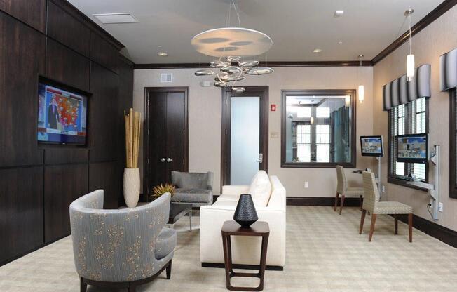 A living room with a grey sofa and a white armchair at Vermella Lyndhurst apartments, Lyndhurst, NJ
