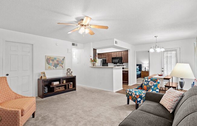 a living room with a couch and a ceiling fan