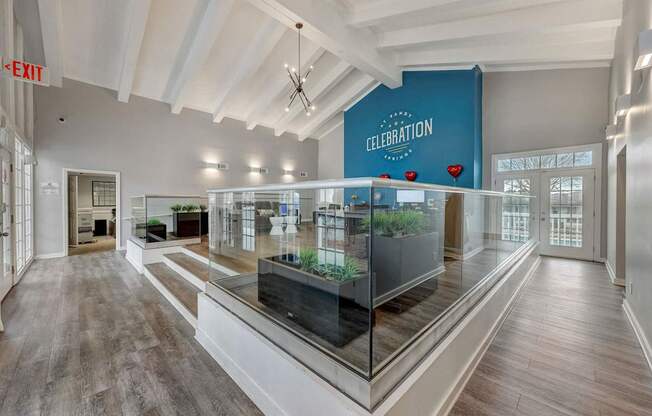 A spacious room with a glass display case in the center and a sign that reads "CELEBRATION".