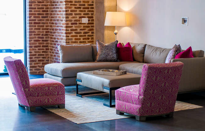 a living room with a couch and two chairs