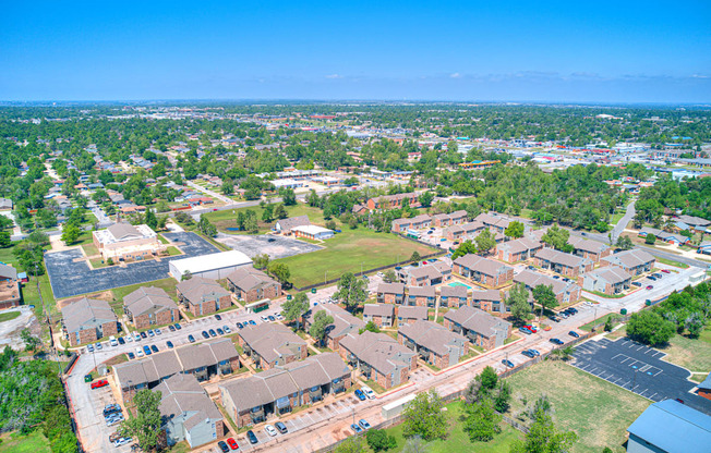 an aerial view of a neighborhood with houses and cars on the street